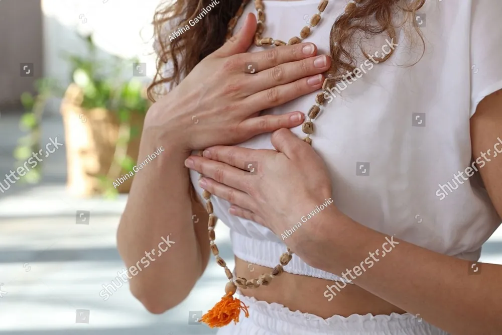 A woman resting her hands on her heart